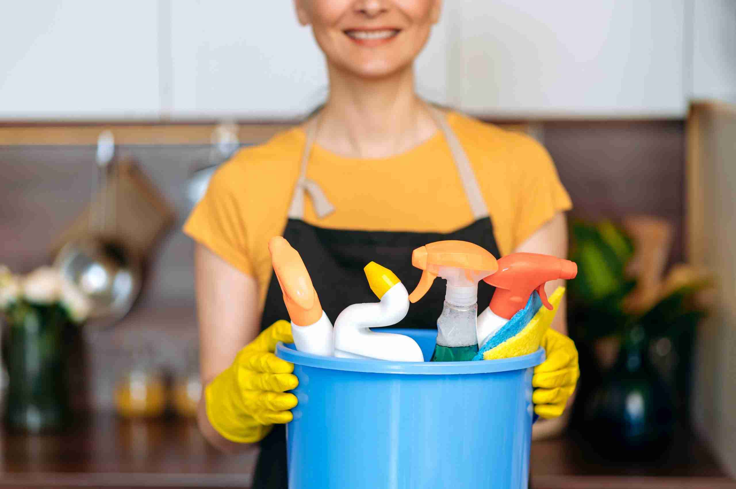 lady with cleaning supplies for house cleaning services